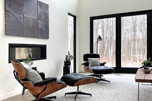 black leather padded armchair near black wooden framed glass window