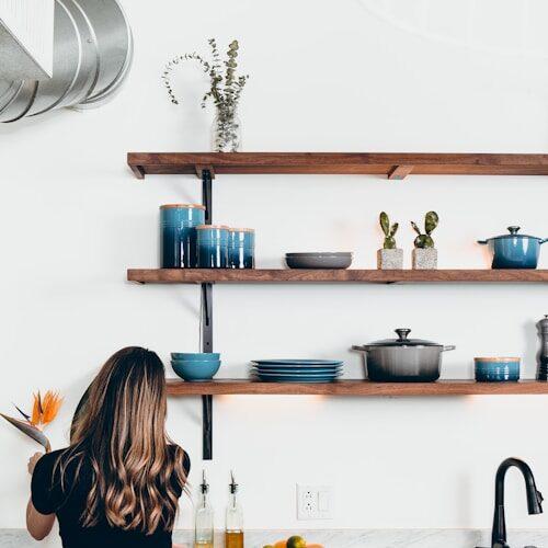 woman standing in front of kitchen sink