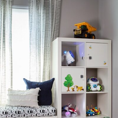 a child's room with a bookcase and toys