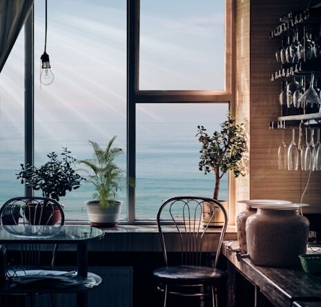 black bar stool near glass window