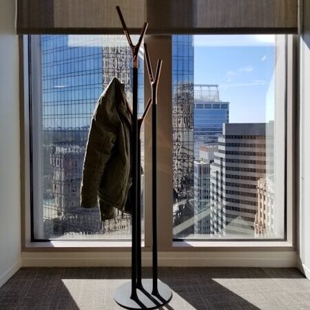 green jacket on a coat rack