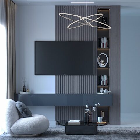a room with a tv and a shelf with books