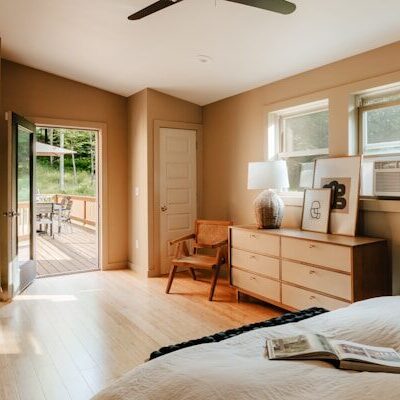 A bedroom with a large bed and a ceiling fan