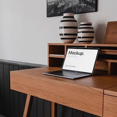 black laptop computer on brown wooden desk