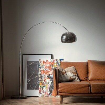brown wooden framed white padded armchair beside white wall